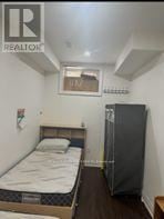 Toronto (Oakridge) apartment for rent - A bedroom with a bed, wardrobe and window.