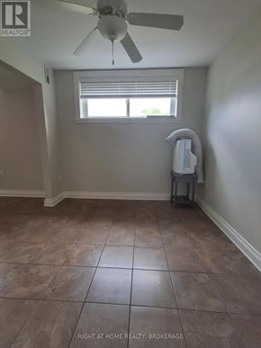 St. Catharines (Port Dalhousie) duplex for rent - A room with tile flooring and a ceiling fan.
