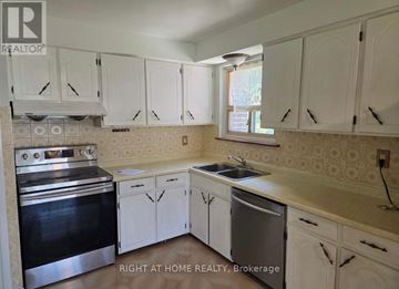 Mississauga (Applewood) apartment for rent - A kitchen with white cabinets and a stainless steel oven.