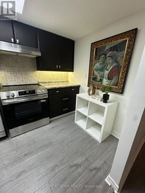 Toronto (Rosedale-Moore Park) condo for rent - A kitchen with black cabinets and a framed painting on the wall.