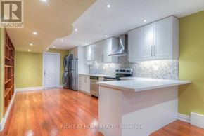 Vaughan (Patterson) apartment for rent - A kitchen with yellow walls and white cabinets.