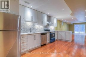 Vaughan (Patterson) apartment for rent - A kitchen with a refrigerator on the left and a stove top oven in the middle.