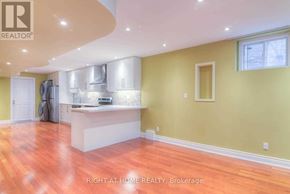 Vaughan (Patterson) apartment for rent - A kitchen with a white island and wooden floors.