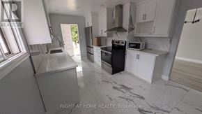 Toronto (Humber Summit) apartment for rent - A kitchen with a black oven and white cabinets.