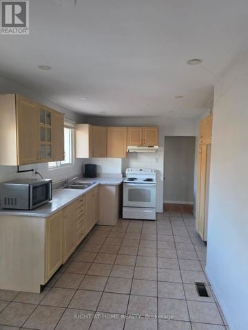 Toronto (Humber Summit) apartment for rent - A kitchen with a microwave, oven, and cabinets.
