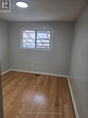Toronto (Humber Summit) apartment for rent - A room with wooden flooring and a window.