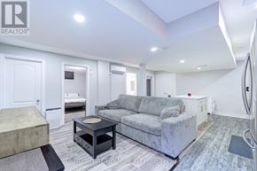 Mississauga (Lisgar) apartment for rent - A living room with a grey couch and a black coffee table.