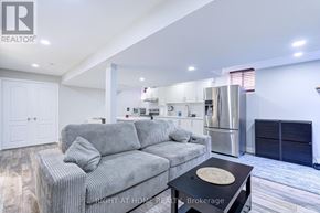 Mississauga (Lisgar) apartment for rent - A modern living room with a grey sofa and a black coffee table.