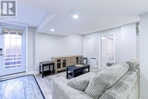 Mississauga (Lisgar) apartment for rent - A living room with a grey sofa and a wooden coffee table.