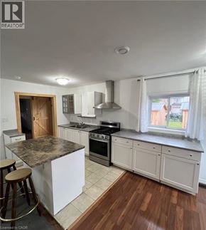 Fort Erie apartment for rent - A kitchen with white cabinets and a granite countertop.