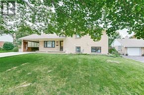 Simcoe apartment for rent - A house with a green lawn and trees in front.