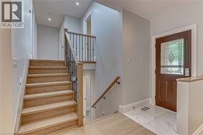 Simcoe apartment for rent - A wooden staircase with a metal railing leads to a second floor.