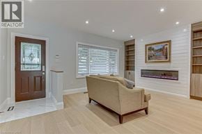 Simcoe apartment for rent - A living room with a couch, a fireplace, and a painting on the wall.