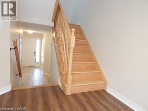 Hannon townhouse for rent - A wooden staircase leads to a white door.