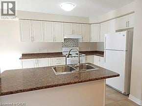 Hannon townhouse for rent - A kitchen with a sink and a refrigerator.