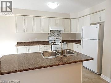 Hannon townhouse for rent - A kitchen with a sink and a refrigerator.