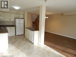 Hannon townhouse for rent - A kitchen with white appliances and wooden floors.