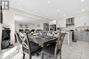 Brantford apartment for rent - A modern kitchen with a dining table set for four.