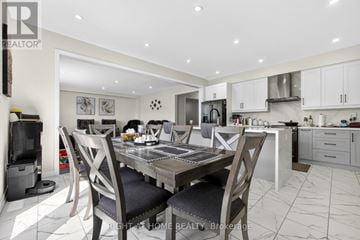 Brantford apartment for rent - A modern kitchen with a dining table set for four.