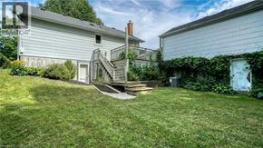 Cambridge apartment for rent - A house with a white exterior and a small front yard with a staircase leading to the front door.