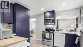 Cambridge apartment for rent - A kitchen with dark blue cabinets and stainless steel appliances.