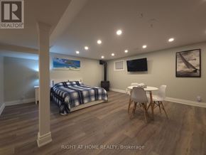 Mississauga (Rathwood) apartment for rent - A bedroom with a bed, chair, and a painting on the wall.