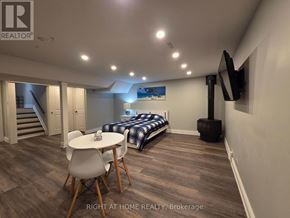 Mississauga (Rathwood) apartment for rent - A bedroom with a bed, a table and chairs, and a television.