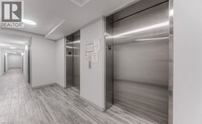 Waterloo condo for rent - A hallway with a realtor sign on the wall.