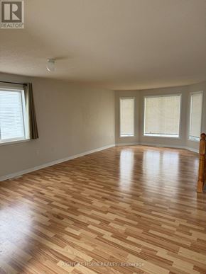 Barrie (Georgian Drive) apartment for rent - A room with wooden flooring and a window.