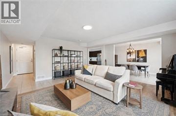Guelph townhouse for rent - A living room with a white couch and a piano.