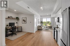 Brantford condo for rent - A well-lit, modern open-plan living and working space with a kitchen area.