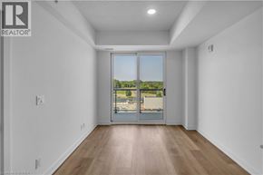 Brantford condo for rent - A room with a sliding glass door leading to a balcony.
