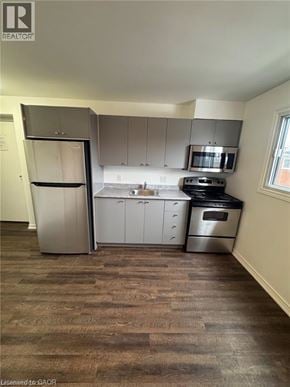Kitchener apartment for rent - A kitchen with a refrigerator, oven, and microwave.