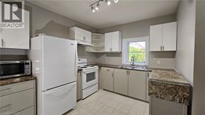 Hamilton apartment for rent - A kitchen with white appliances and cabinets.
