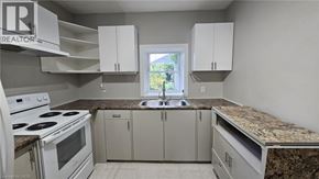 Hamilton apartment for rent - A kitchen with a white stove and cabinets.