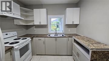 Hamilton apartment for rent - A kitchen with a white stove and cabinets.