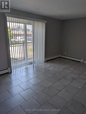 Thorold (Thorold Downtown) multi-family for rent - A room with a sliding glass door and tile flooring.