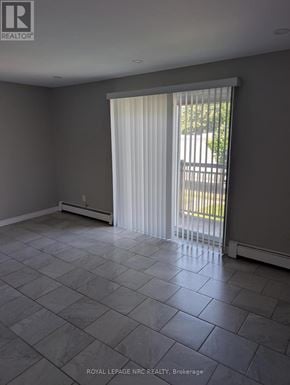 Thorold (Thorold Downtown) multi-family for rent - A room with a sliding door and tiled floor.