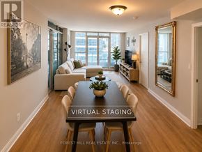Toronto (Waterfront Communities) condo for rent - A dining room with a long table and chairs in the middle of the room.