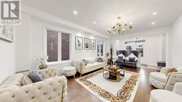 Shelburne apartment for rent - A well-lit, modern living room with a chandelier, a sofa set, and a coffee table.