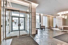 Toronto (Bayview Village) condo for rent - A modern interior of a building with a glass door entrance.