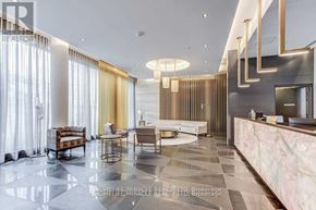 Toronto (Bayview Village) condo for rent - A spacious living room with a marble floor and a reception desk.
