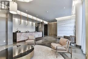 Toronto (Bayview Village) condo for rent - A modern living room with a curved wall and a marble countertop.