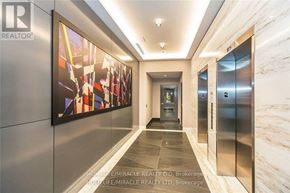 Toronto (Bayview Village) condo for rent - A hallway with a realtor sign on the wall.
