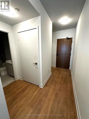 Vaughan (Concord) condo for rent - A hallway with a white door and a brown door.