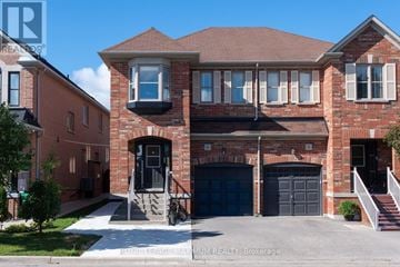 Brampton (Bram East) apartment for rent - A two-story brick house with a garage and a bicycle parked in front.