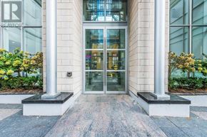Toronto (Waterfront Communities) condo for rent - The front of a building with a glass door and two columns.