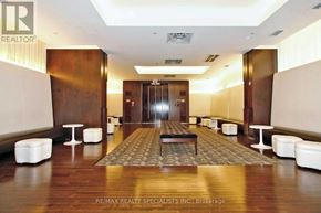 Toronto (Waterfront Communities) condo for rent - A hallway with a carpeted area in the middle and white furniture on the sides.