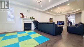 Whitchurch-Stouffville (Stouffville) apartment for rent - A living room with a fireplace and two couches.