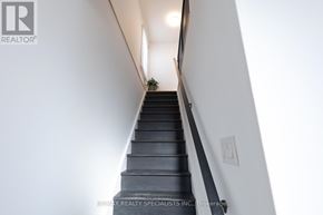 Toronto (Stonegate-Queensway) apartment for rent - A staircase with a black railing and steps leading up to a landing.